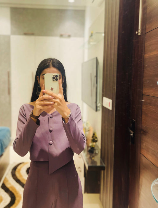 Mirror selfie of woman wearing dusty purple co-ord set with asymmetric button top and straight pants