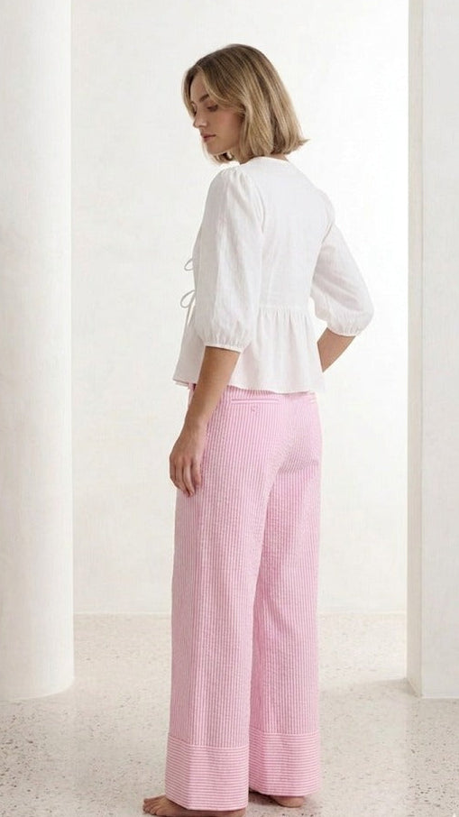 Pink striped seersucker pants with relaxed straight-leg silhouette back view