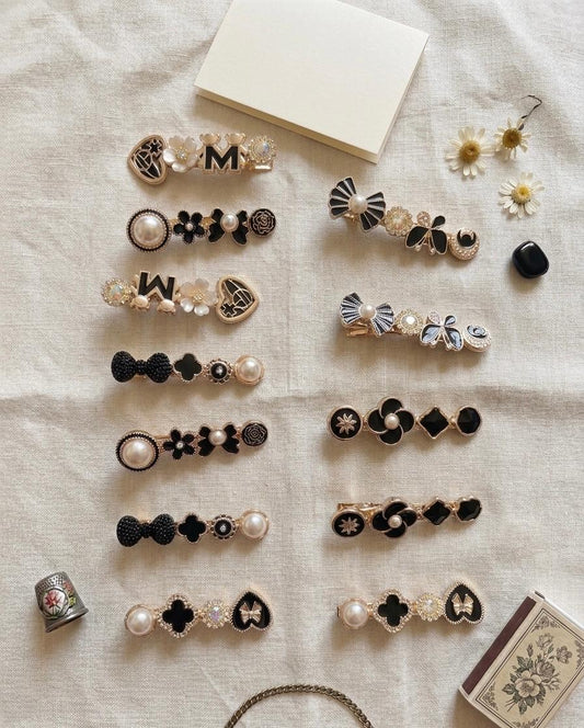 Black and gold hair pins set of 6 pairs with elegant designs on soft background