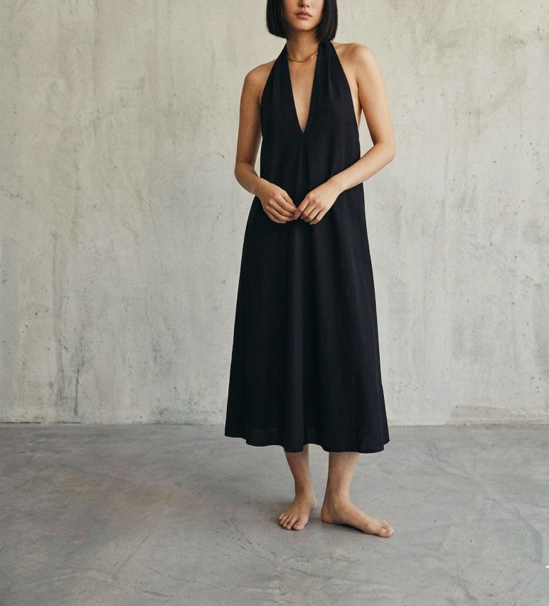 Women’s black halter midi dress with deep V neckline and relaxed A-line silhouette