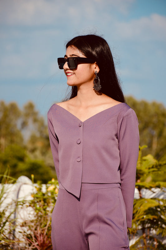 Close up of dusty purple co-ord set showing neckline button detailing and fabric texture